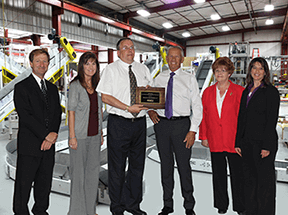 Staff poses with award